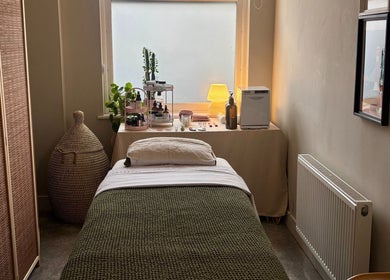 Tranquil therapy room at Aceso Healing Therapies, Margate, England, GB, featuring a bed and skincare products.