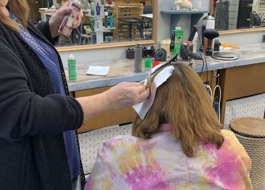 Professional hairstylist coloring client's hair at apPIERances Salon & Barbering in Lititz, Pennsylvania, US.