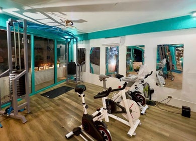 Modern fitness area at Detox Wellness, San Fernando, Ilocos Region, PH, featuring sleek exercise bikes and gym equipment.