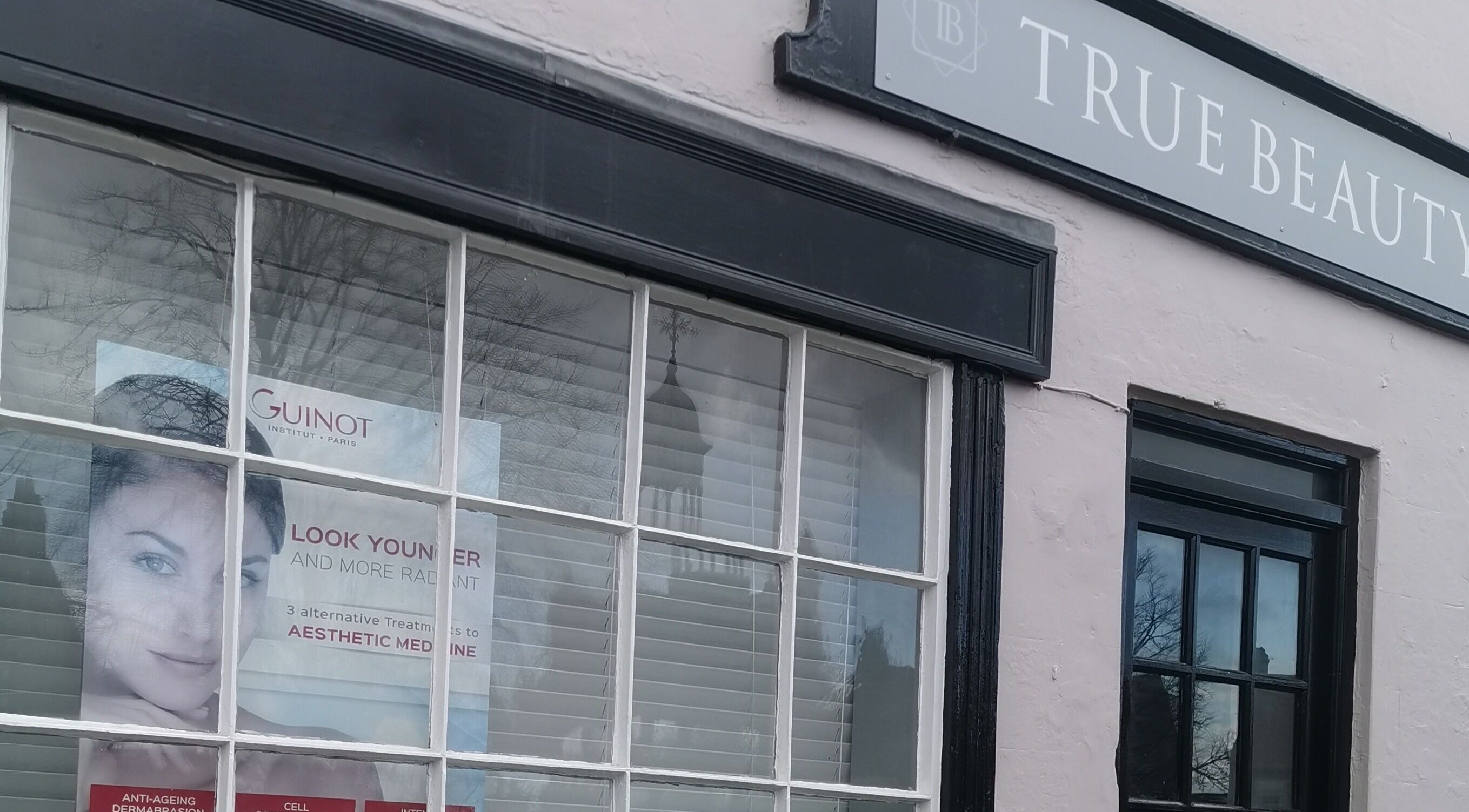 Shopfront of True Beauty Boroughbridge in Boroughbridge, England, GB, showcasing a poster of skincare services.