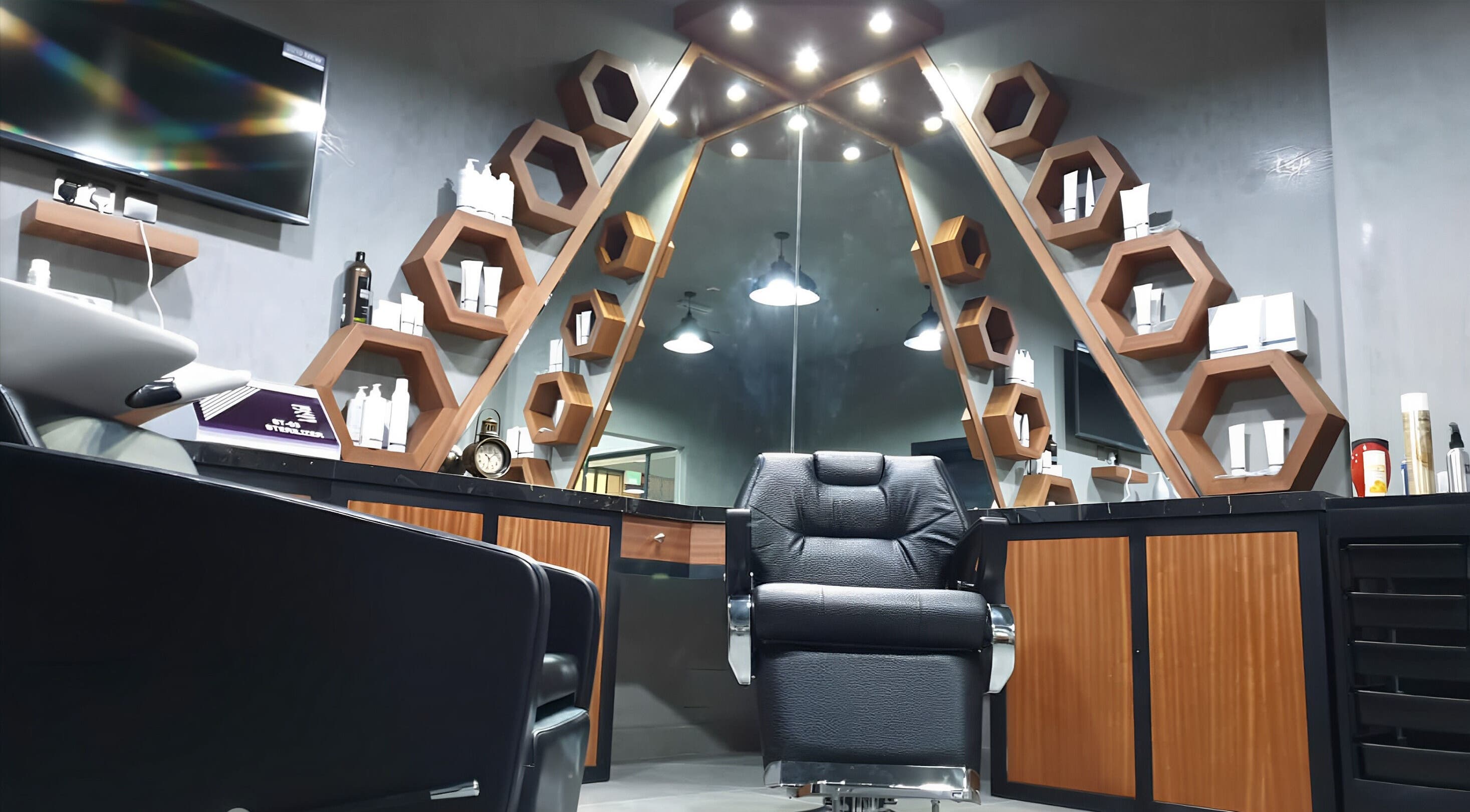 Modern styling area at Le Coiffeur Salon Dar-Al-Salam, الدوحة, الريان, QA with sleek chair and hexagon shelves.