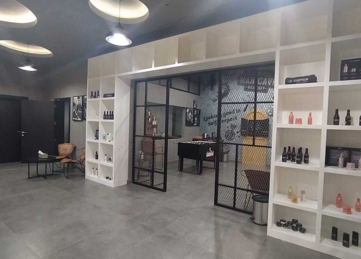 Chic interior of Le Coiffeur Salon Dar-Al-Salam, الدوحة, الريان, QA showcasing sleek decor and product shelf.