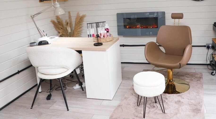 Stylish salon interior at Bennett’s Beauty Bar in Liskeard, England, GB showcasing elegant seating and decor.