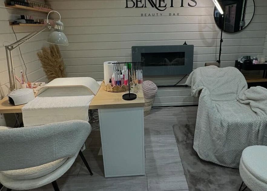 Nail service area at Bennett’s Beauty Bar, Liskeard, England, GB, featuring plush seating and modern decor.