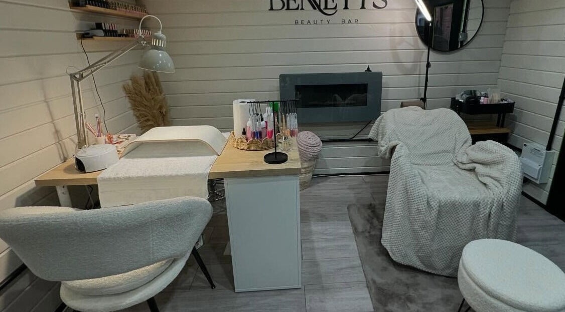 Nail service area at Bennett’s Beauty Bar, Liskeard, England, GB, featuring plush seating and modern decor.