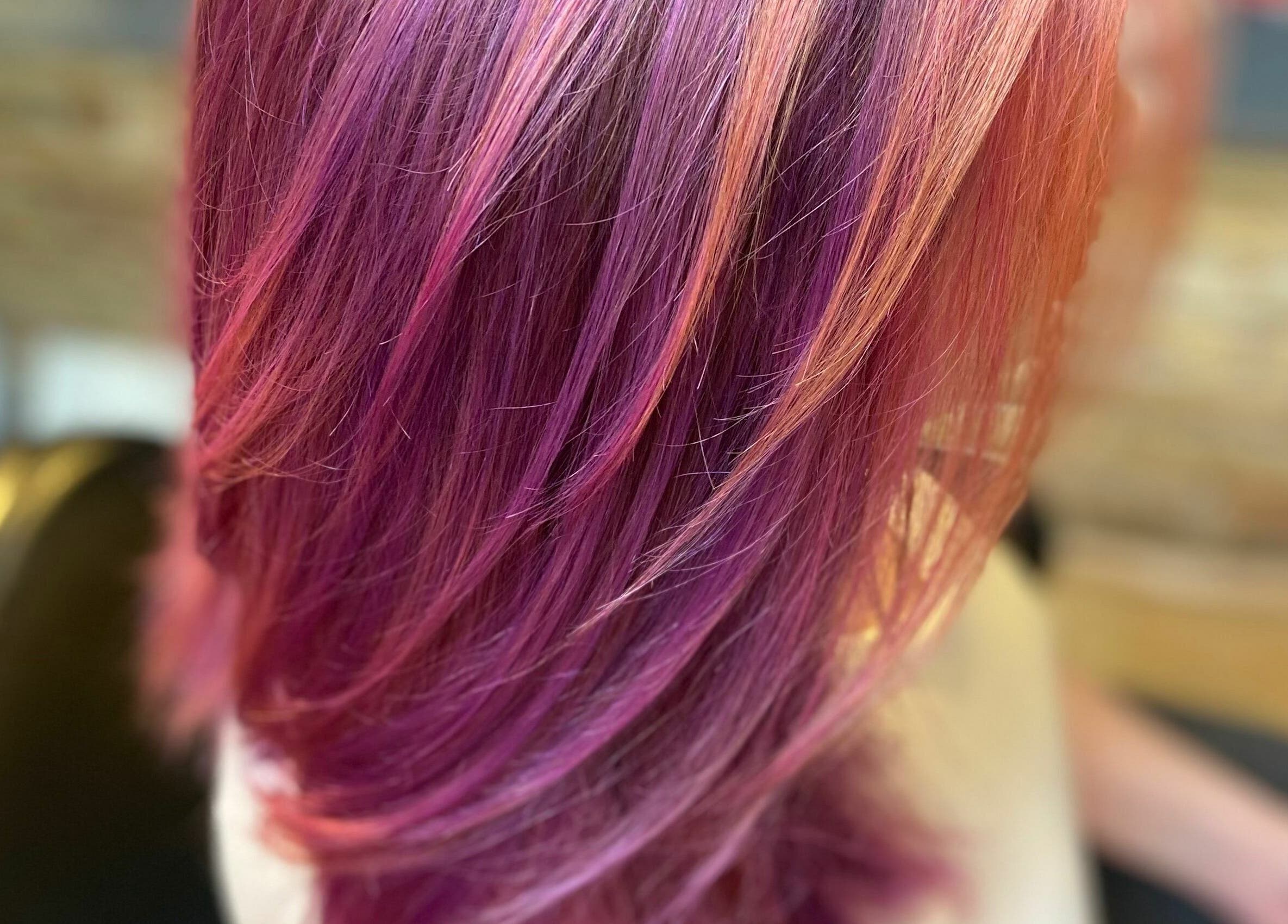 Vibrant purple hair styled at Aaries Styles Salon, Ypsilanti, Michigan, US, showcasing expert coloring.