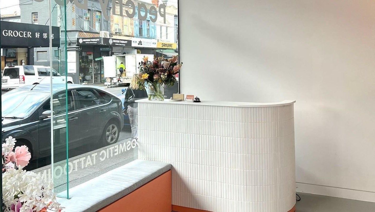 Reception area at Peachy Beauty in Hawthorn, Victoria, AU with stylish decor and vibrant flowers.