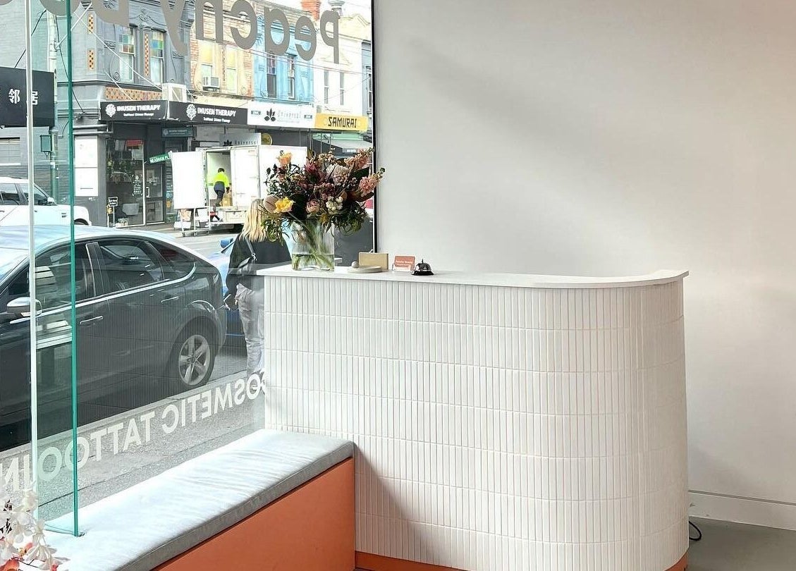 Reception area at Peachy Beauty in Hawthorn, Victoria, AU with stylish decor and vibrant flowers.