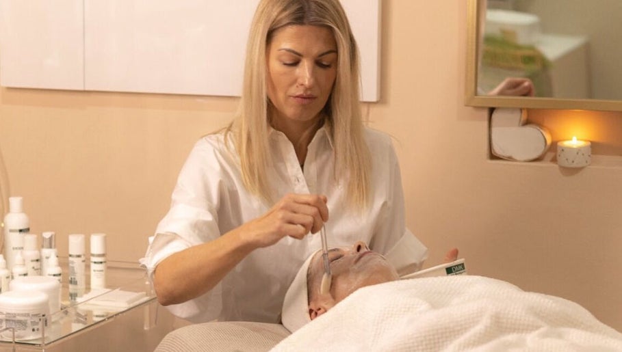 A woman applies a facial mask at Vertex Cosmetology in Cape Town, Western Cape, ZA.