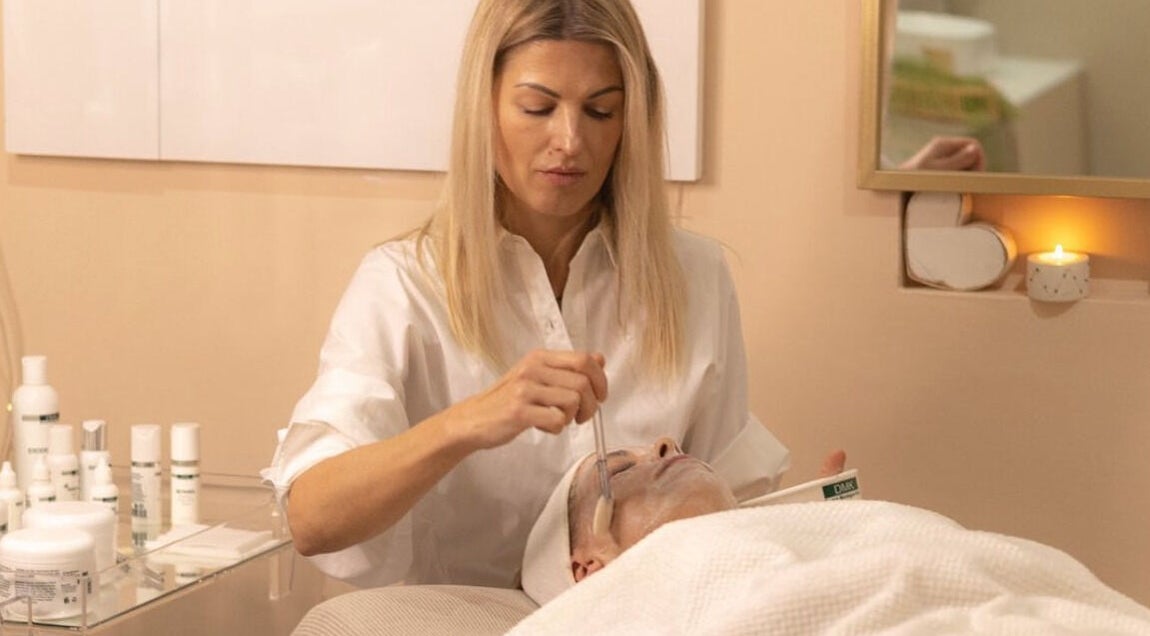 A woman applies a facial mask at Vertex Cosmetology in Cape Town, Western Cape, ZA.