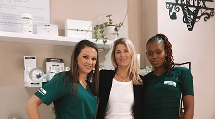 Team at Vertex Cosmetology, Cape Town, Western Cape, ZA, smiling warmly in a welcoming beauty setting.