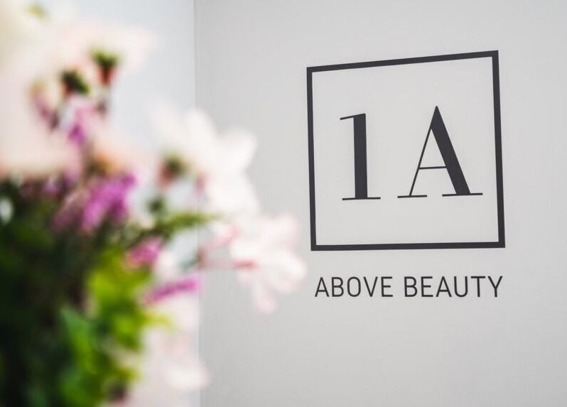 Signage of 1a Above Beauty in Willerby, England, GB with blurred floral foreground.