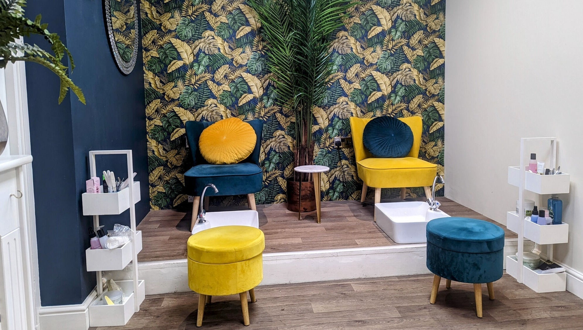 Cozy pedicure area at First Impressions, Shifnal, England, GB, featuring vibrant chairs and tropical decor.
