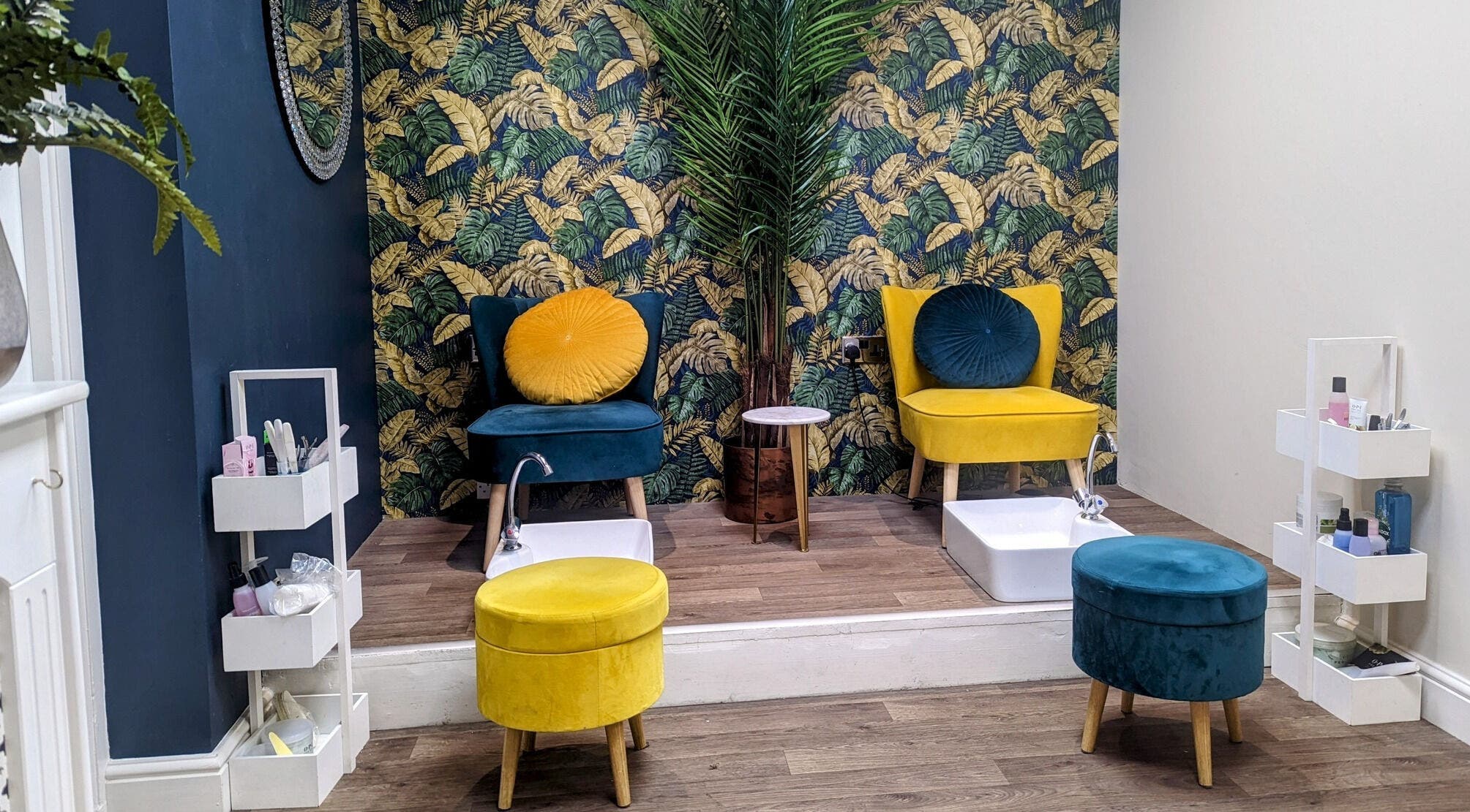 Cozy pedicure area at First Impressions, Shifnal, England, GB, featuring vibrant chairs and tropical decor.