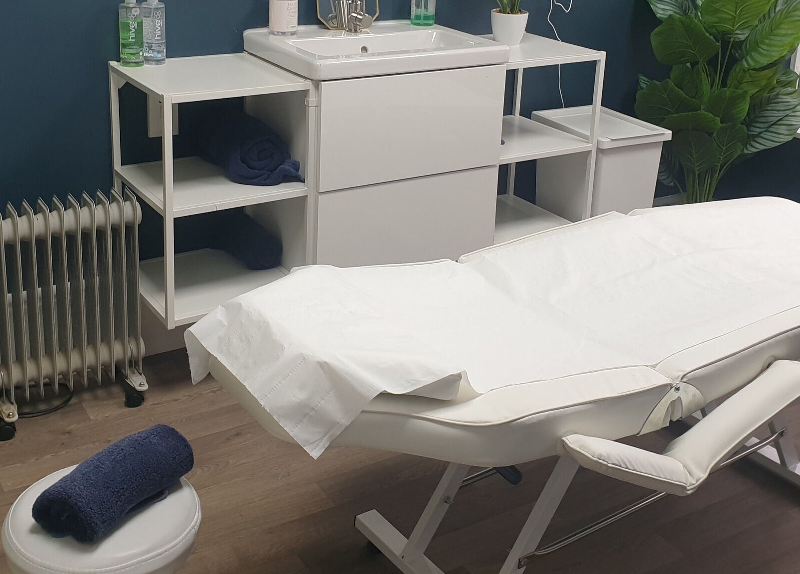 Modern treatment room at First Impressions, Shifnal, England, GB with a white massage table and calming decor.