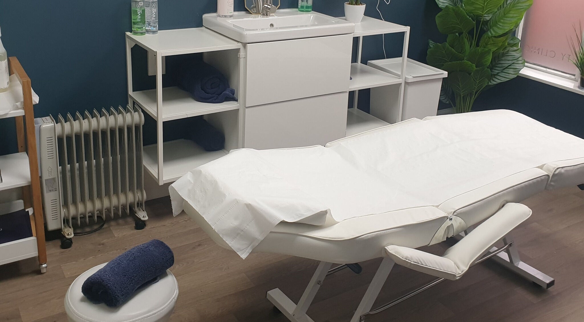 Modern treatment room at First Impressions, Shifnal, England, GB with a white massage table and calming decor.