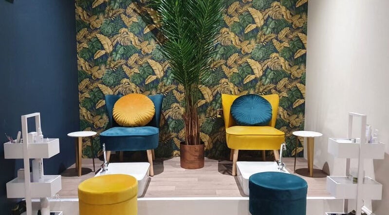 Elegant pedicure area at First Impressions, Shifnal, England, GB with stylish chairs and vibrant decor.