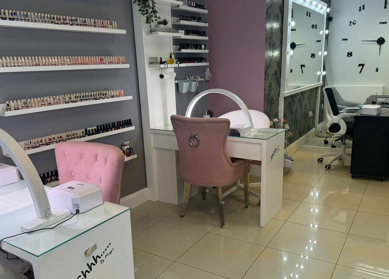 Elegant nail studio at Shhh... by Maggie in Virginia, County Cavan, IE, featuring stylish pink chairs and nail polish display.