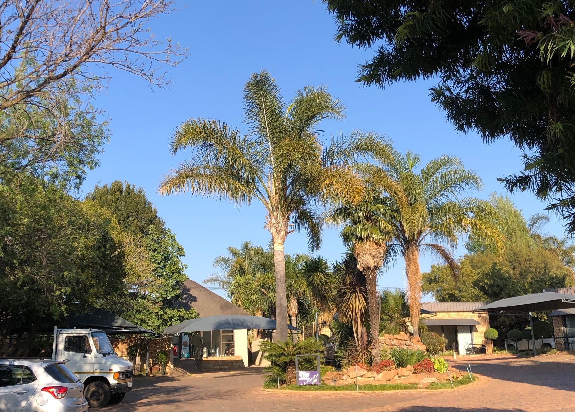 Entrance to The Wax Pots Ruimsig with lush greenery in Roodepoort, Gauteng, ZA.