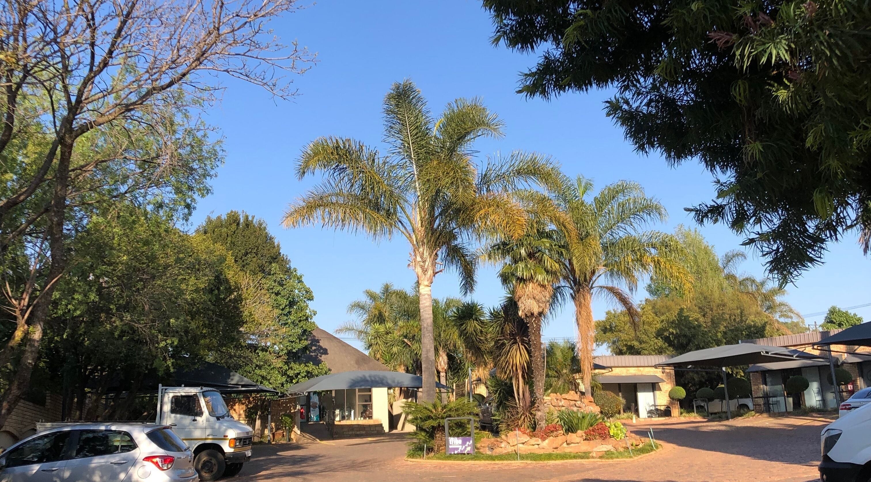 Entrance to The Wax Pots Ruimsig with lush greenery in Roodepoort, Gauteng, ZA.