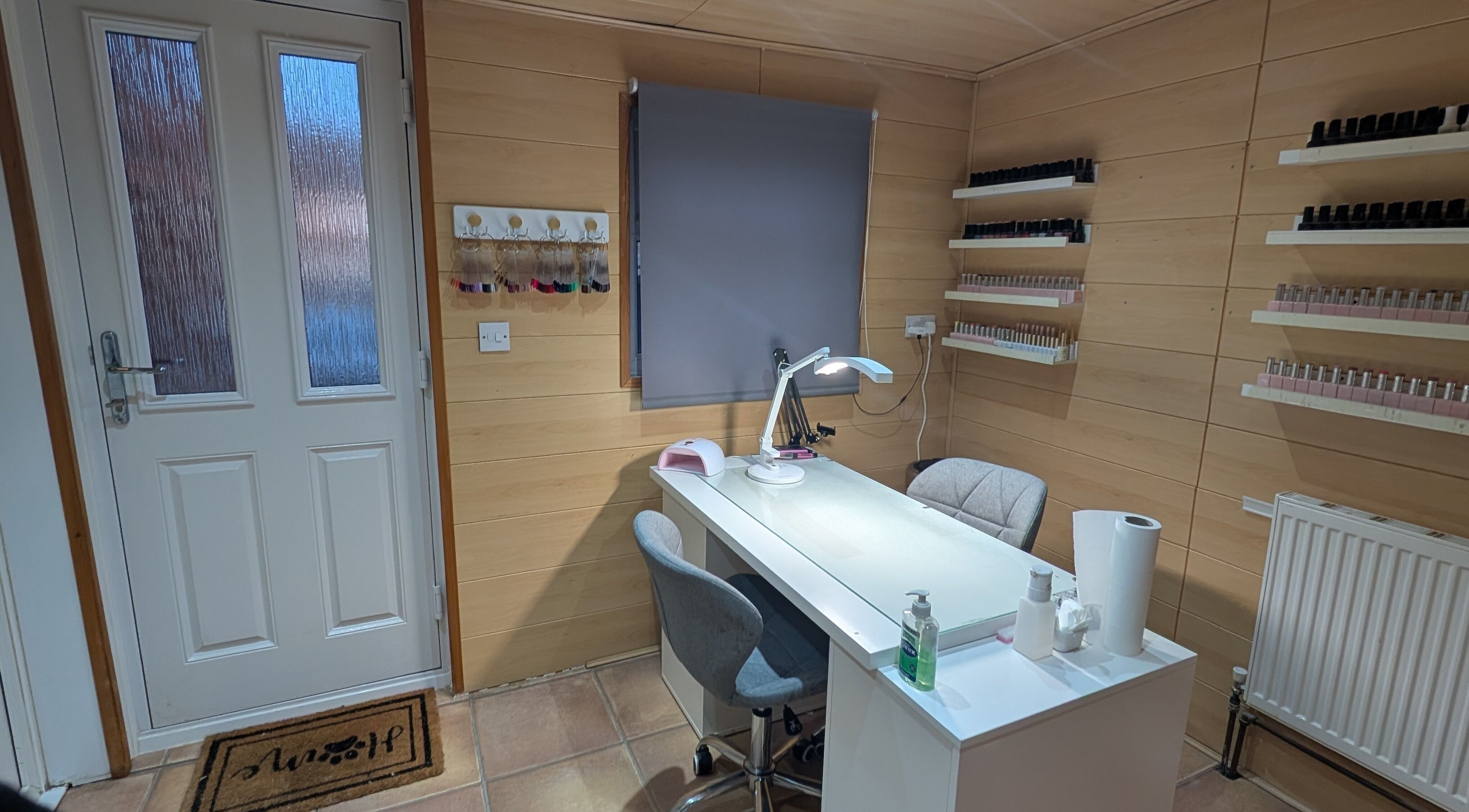 Nail salon workspace at Beauty Matters, Bedworth, England, GB with organized shelves and modern decor.