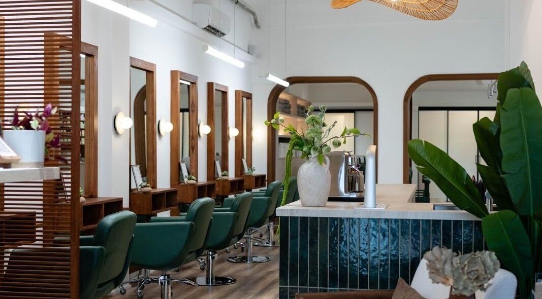 Elegant interior of Love Hair SG salon in Singapore, Singapore, SG with modern chairs and mirrors.