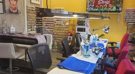 Bright interior of Thai Nails House by Ann, Denver, Colorado, US, featuring colorful nail polish display and cozy seating.