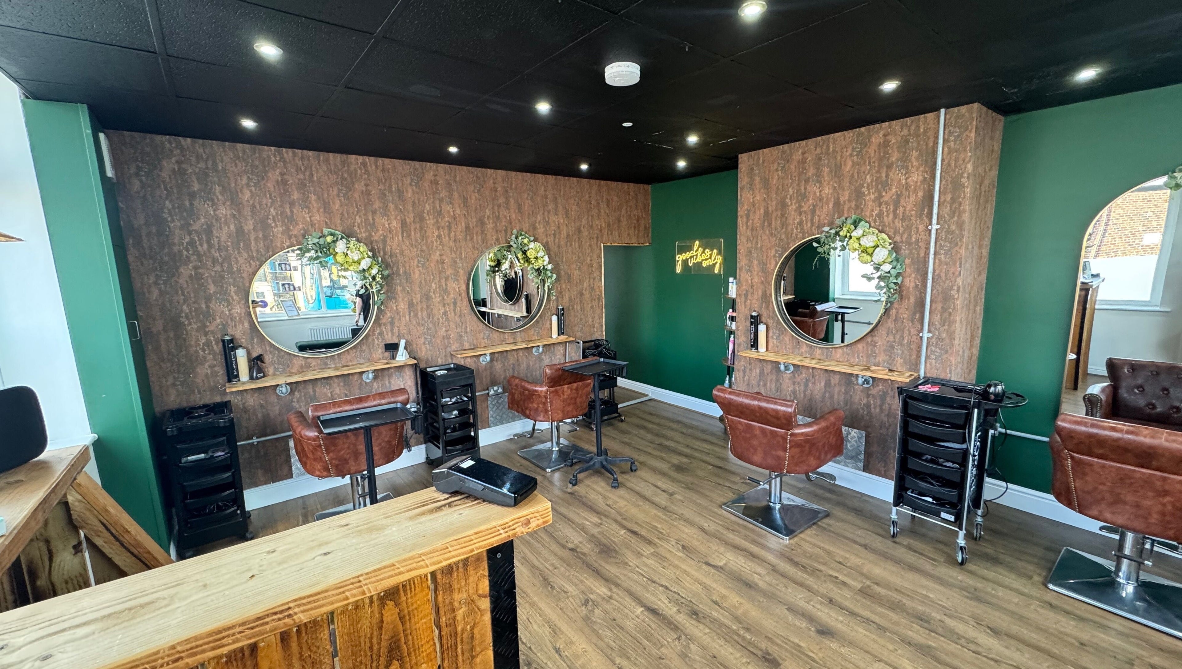 Chic salon at Hair by Demi at UNHIDDEN, Ossett, England, GB with stylish chairs and mirrors.