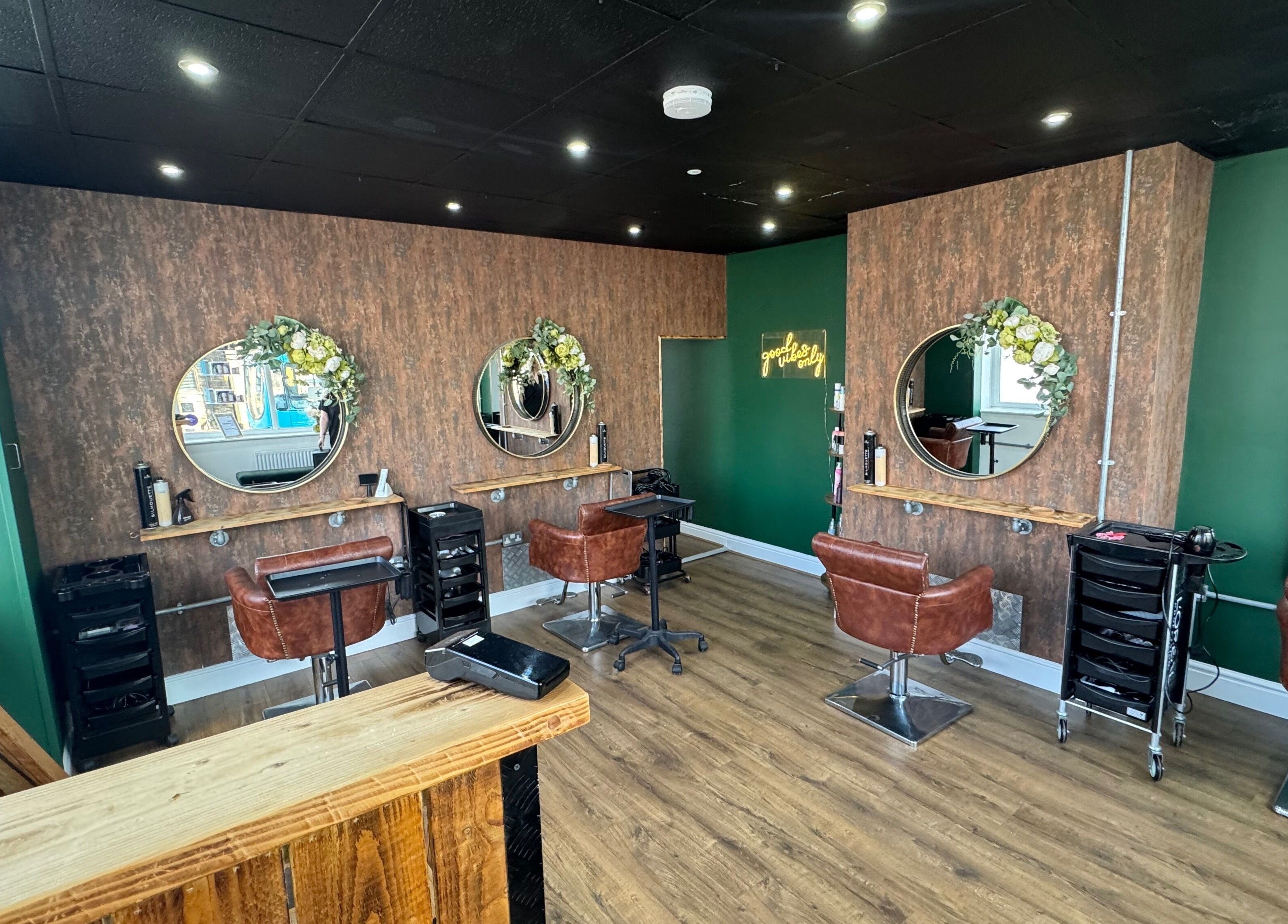 Chic salon at Hair by Demi at UNHIDDEN, Ossett, England, GB with stylish chairs and mirrors.