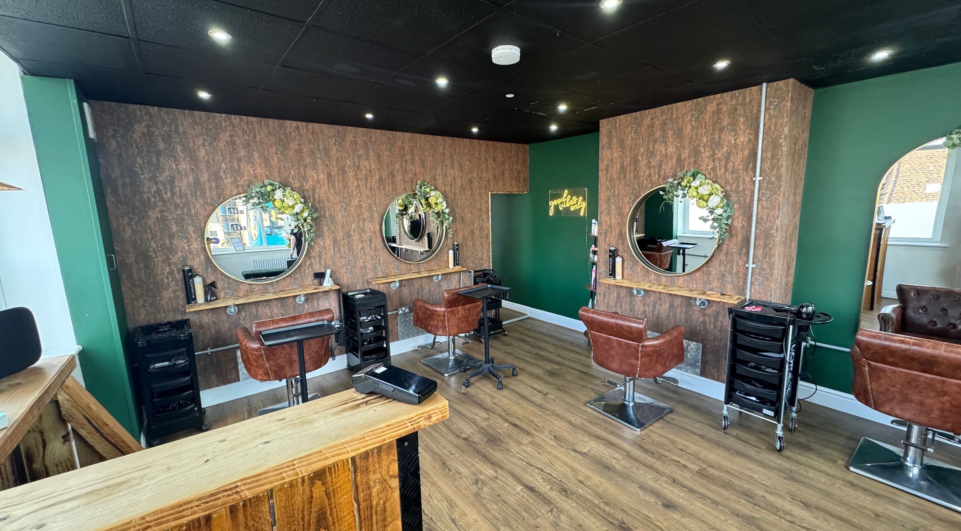 Chic salon at Hair by Demi at UNHIDDEN, Ossett, England, GB with stylish chairs and mirrors.