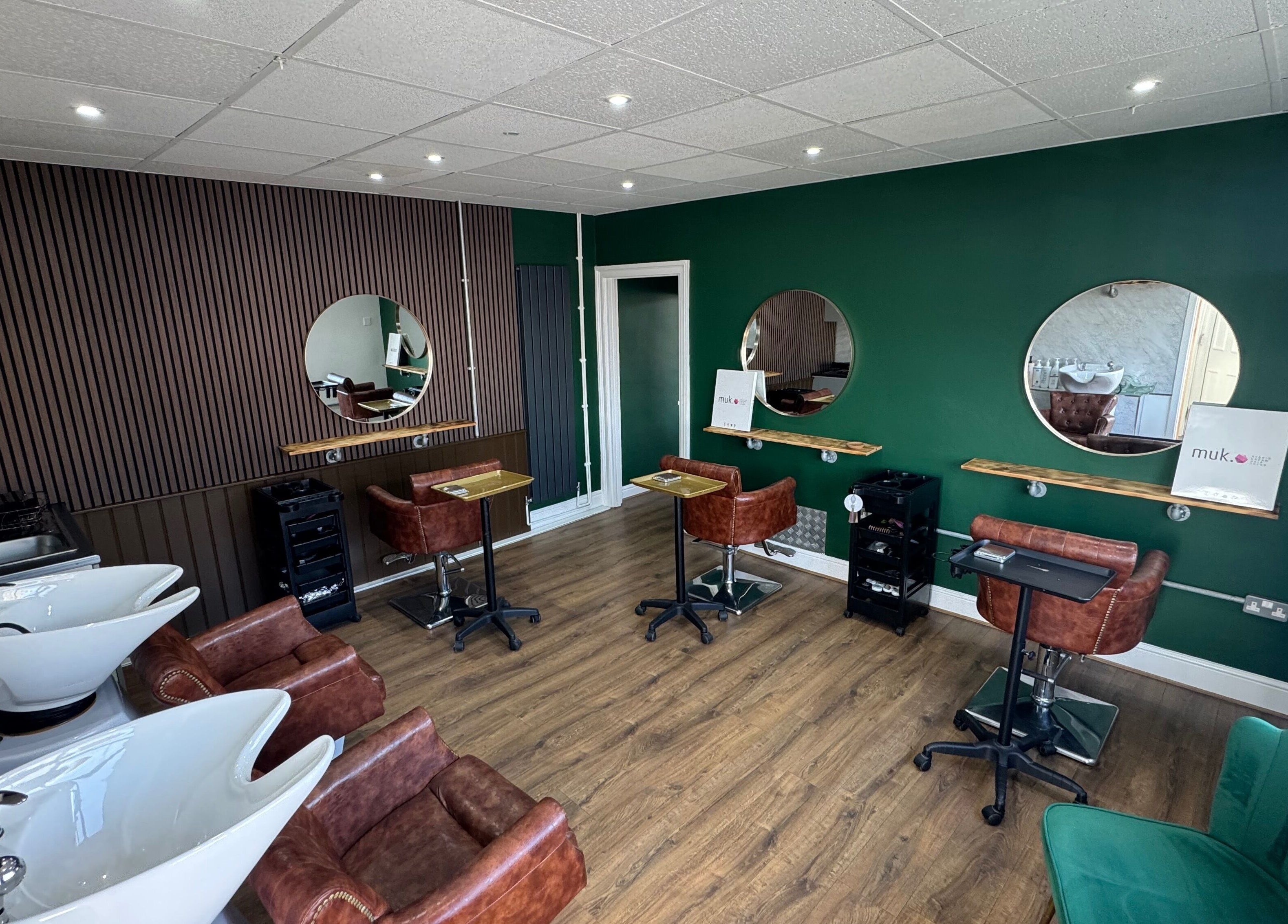 Modern salon interior of Hair by Demi at UNHIDDEN in Ossett, England, GB with stylish decor.