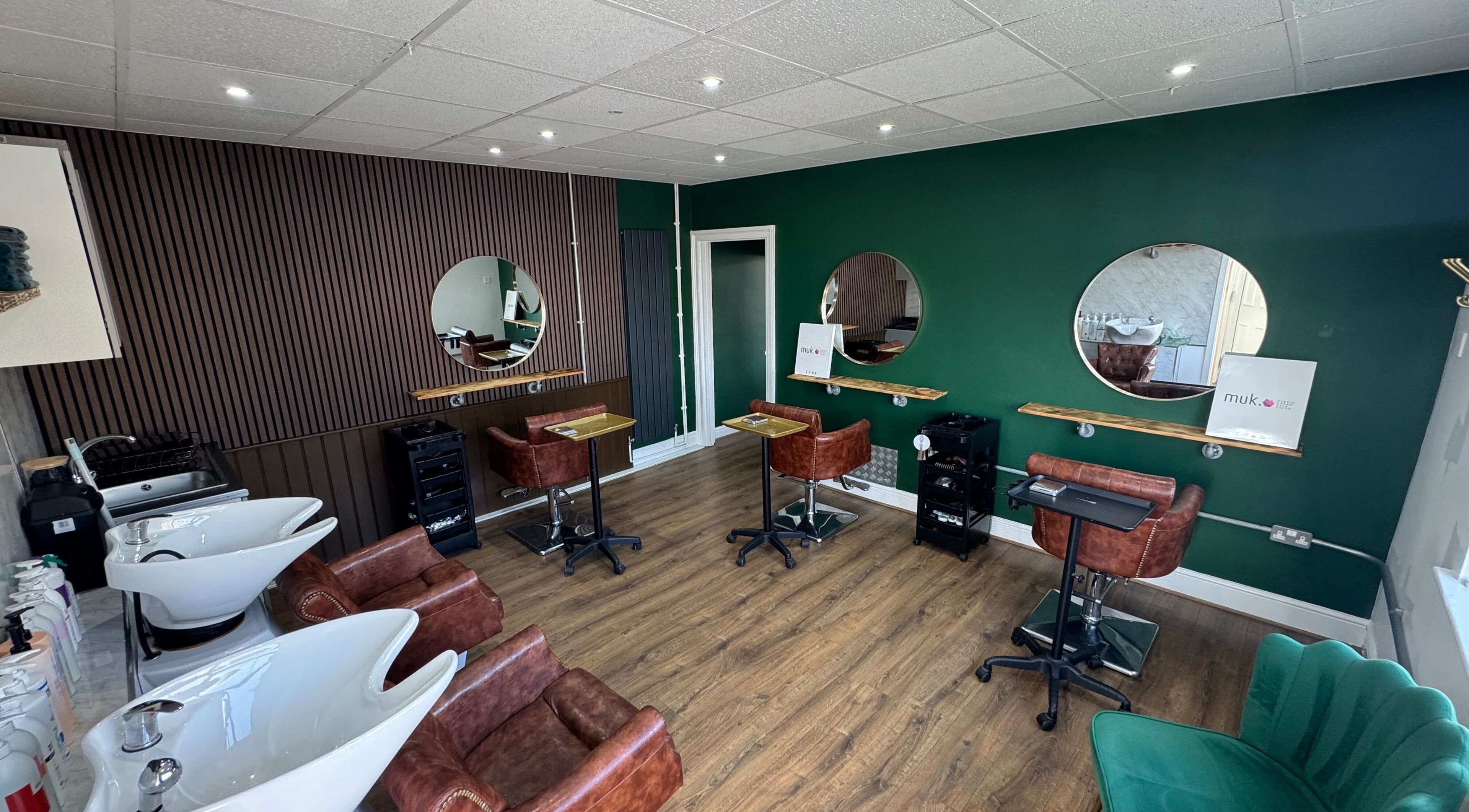 Modern salon interior of Hair by Demi at UNHIDDEN in Ossett, England, GB with stylish decor.