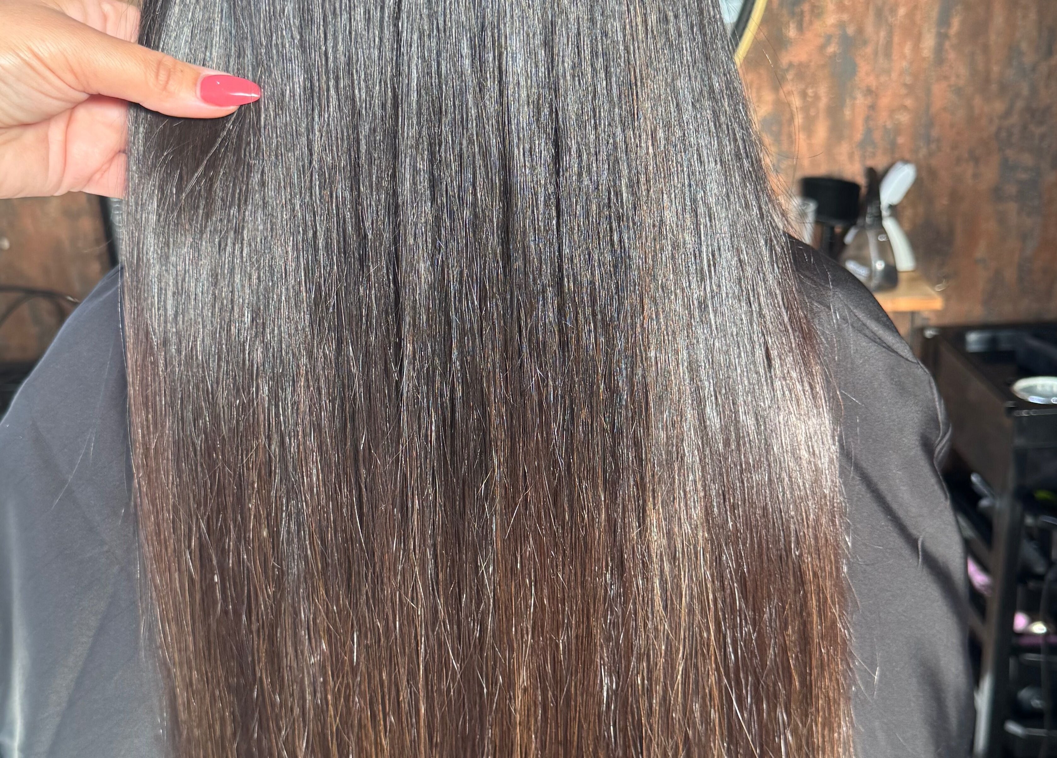 Smooth, straight hair finished at Hair by Demi at UNHIDDEN, Ossett, England, GB, reflecting sleek health.