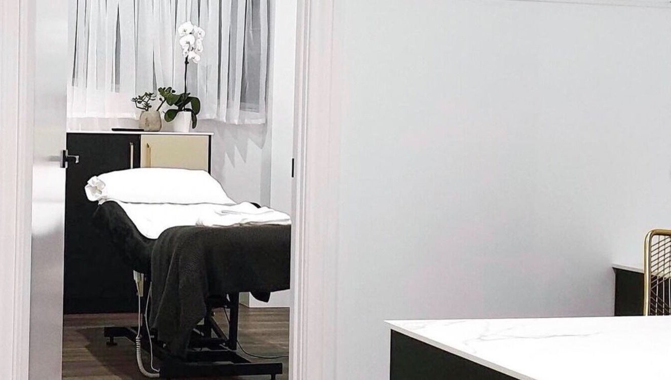 Modern Aesthetics treatment room in Woolooware, New South Wales, AU with a comfortable white massage bed.