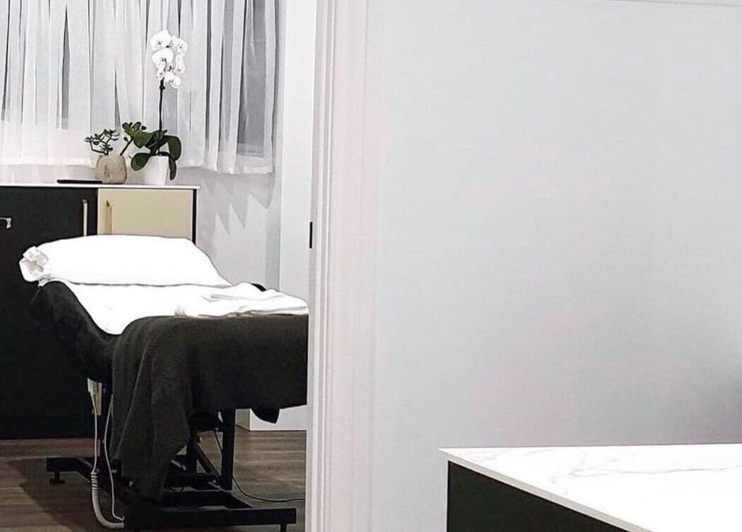 Modern Aesthetics treatment room in Woolooware, New South Wales, AU with a comfortable white massage bed.