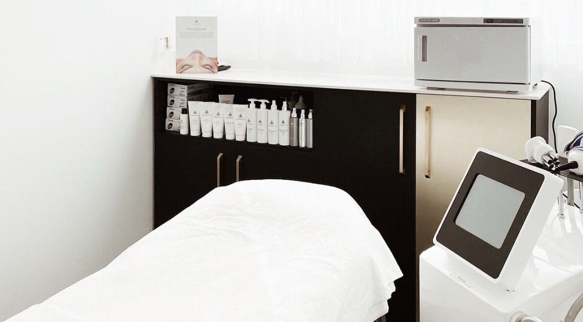 Modern Aesthetics treatment room in Woolooware, New South Wales, AU, featuring skincare products and equipment.