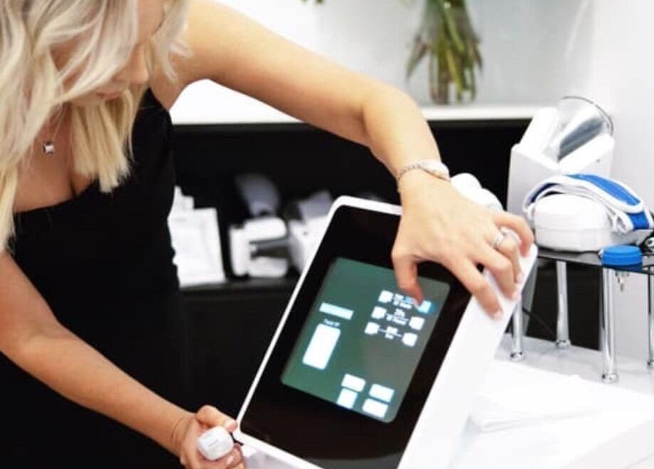 Staff member uses advanced beauty equipment at Modern Aesthetics, Woolooware, New South Wales, AU.