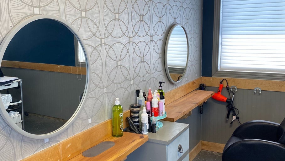 Styling station at Gatehouse Salon in Sault Ste Marie, Ontario, CA with mirrors and hair products.