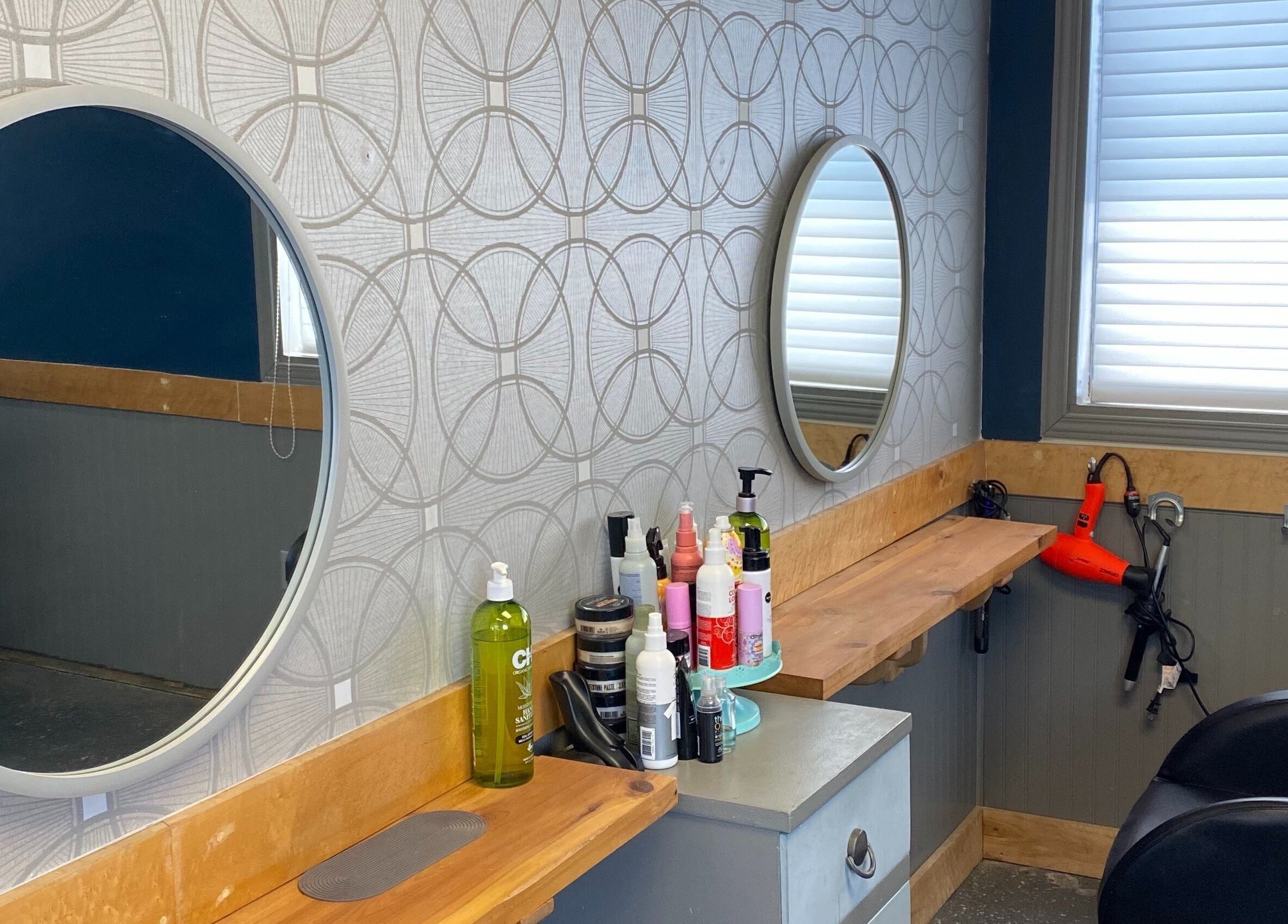 Styling station at Gatehouse Salon in Sault Ste Marie, Ontario, CA with mirrors and hair products.