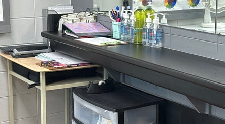 Neat workspace at Gatehouse Salon, Sault Ste Marie, Ontario, CA with salon supplies and a laptop.