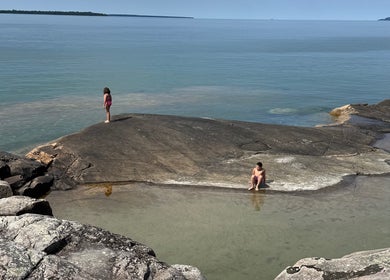 Visitors enjoying serene waters near Gatehouse Salon, Sault Ste Marie, Ontario, CA.