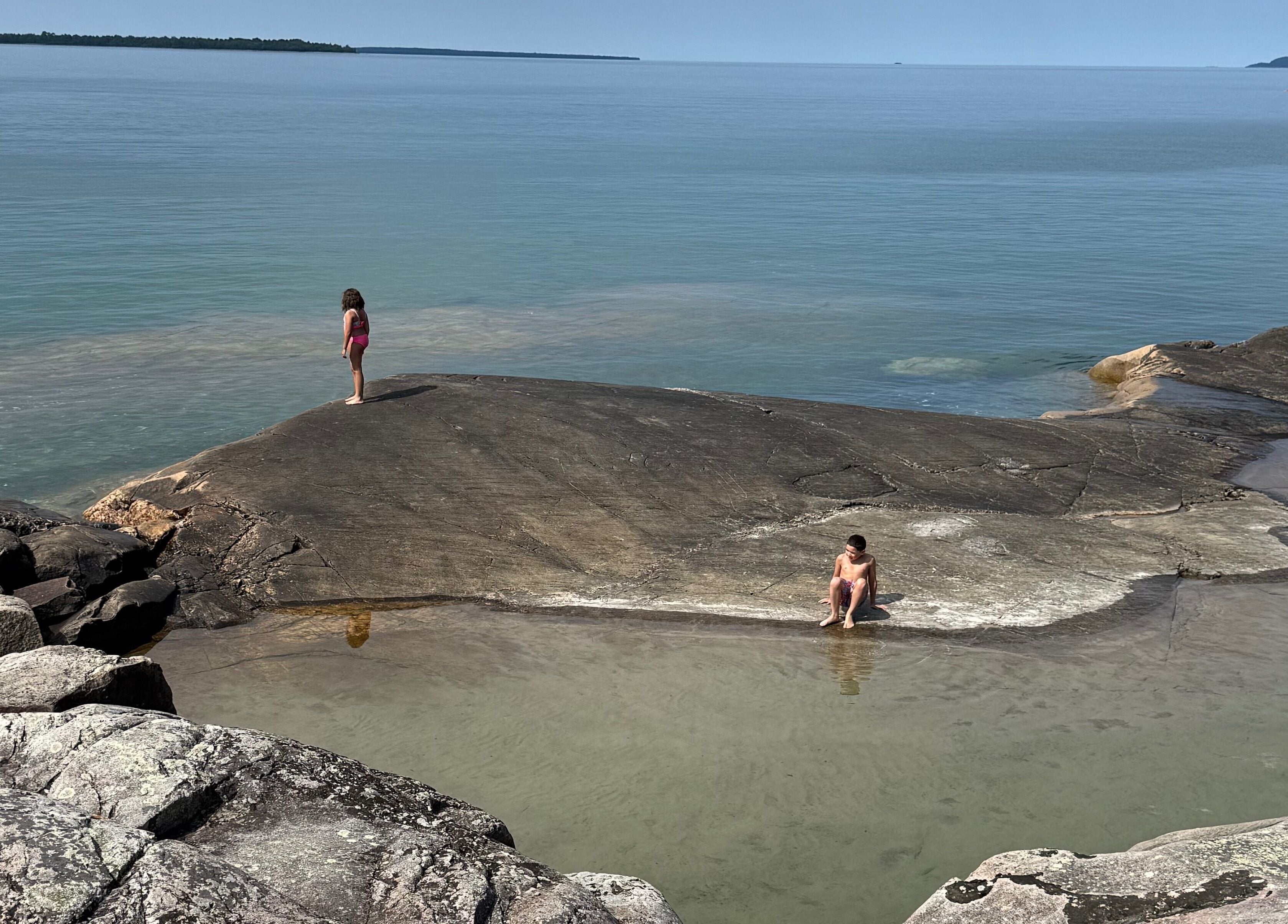 Visitors enjoying serene waters near Gatehouse Salon, Sault Ste Marie, Ontario, CA.