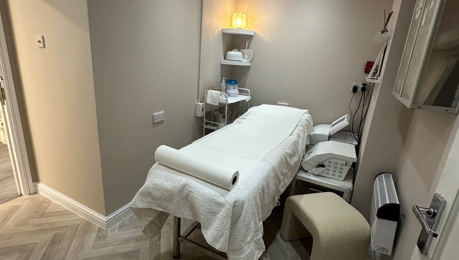 Cozy treatment room at Exclusive Beauty Spa, Sutton Coldfield, England, featuring a neatly arranged massage table.