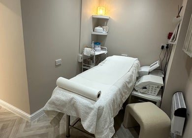 Cozy treatment room at Exclusive Beauty Spa, Sutton Coldfield, England, featuring a neatly arranged massage table.