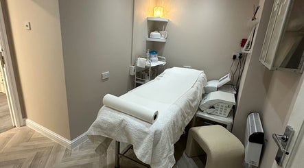 Cozy treatment room at Exclusive Beauty Spa, Sutton Coldfield, England, featuring a neatly arranged massage table.