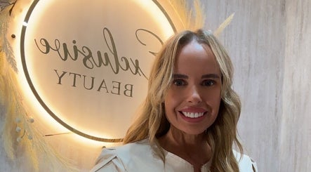 Exclusive Beauty Spa logo with visitor smiling in Sutton Coldfield, England, GB.