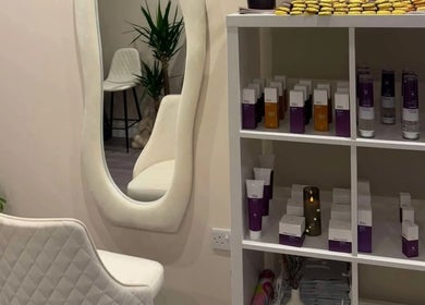 Elegant interior at Leyabelle Esthetic Clinic, Barking, England with products and stylish mirror setup.