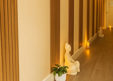Serene hallway with candles and sculptures at Leyabelle Esthetic Clinic, Barking, England, GB.