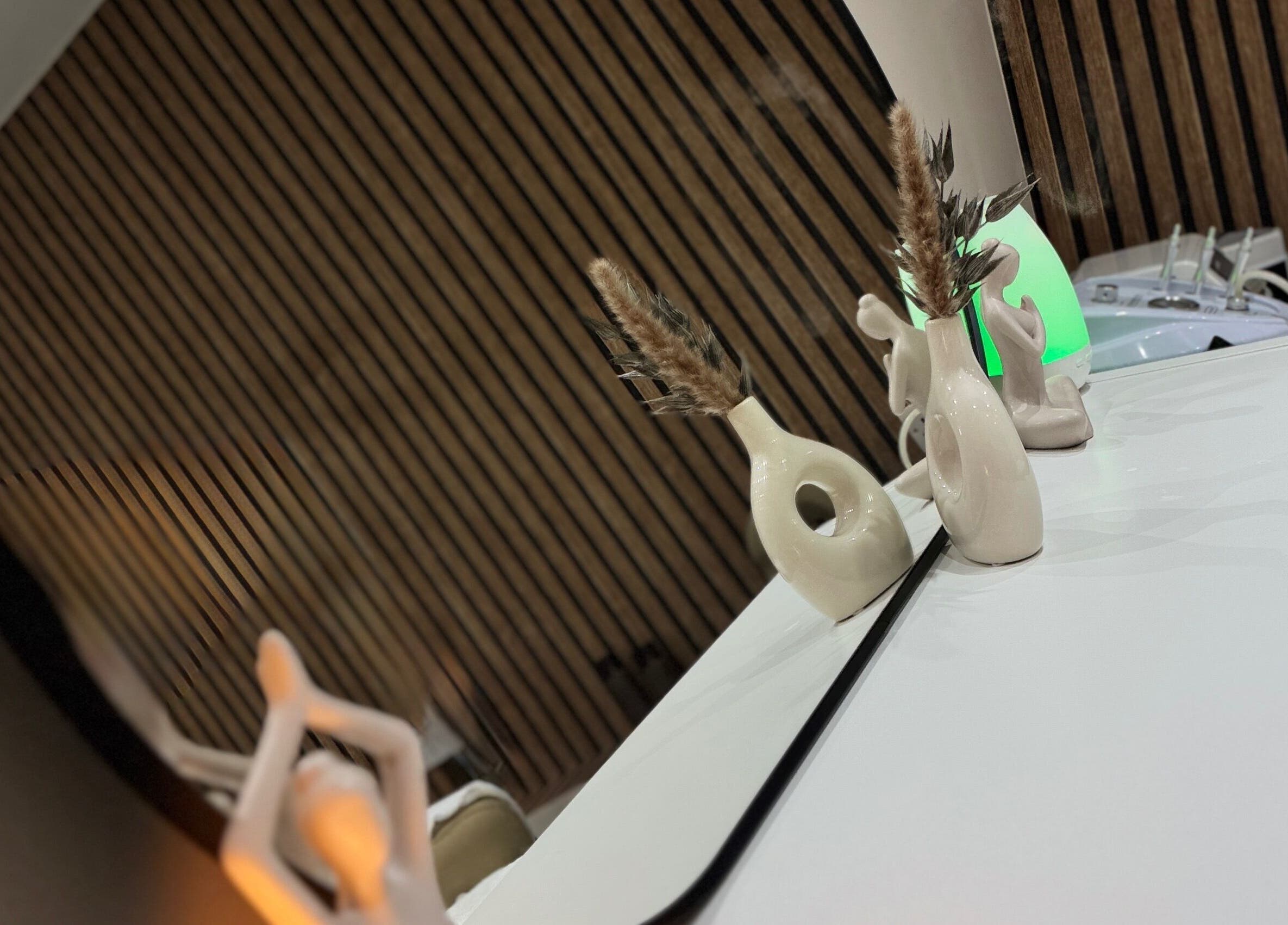 Elegant decor at Leyabelle Esthetic Clinic in Barking, England, GB featuring vases and a mirror reflection.
