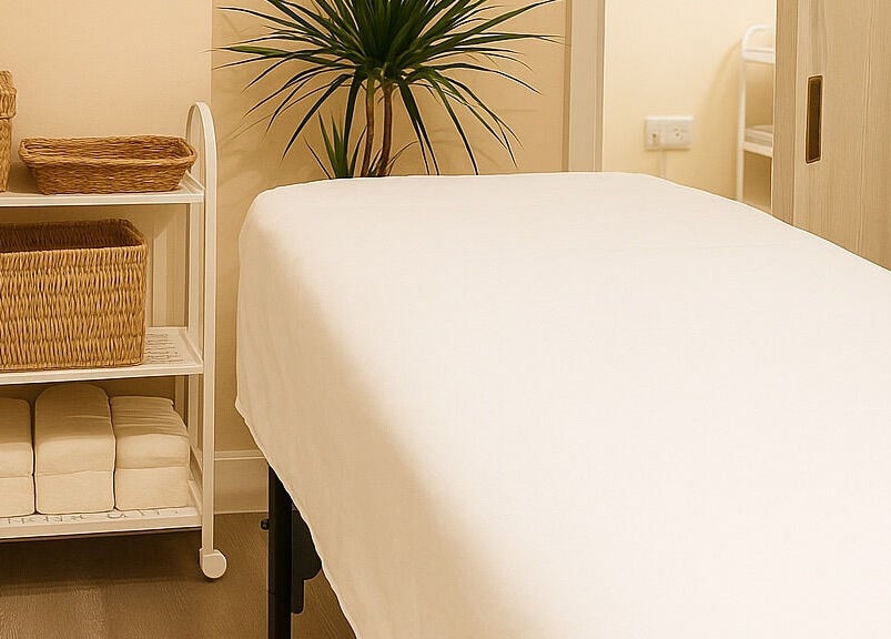 Tranquil treatment room at Leyabelle Esthetic Clinic in Barking, England, GB, with massage bed and plants.